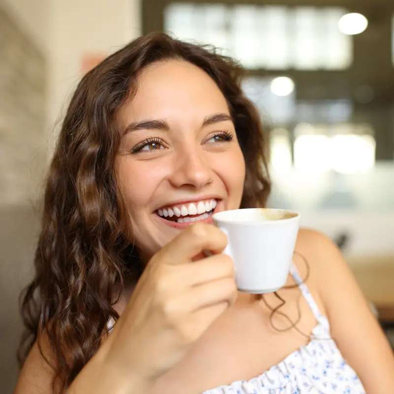 YOUNG WOMAN DRINKING COFFEE
