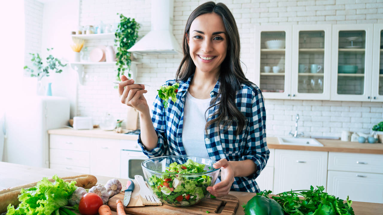 mujer joven en la cocina dieta sana